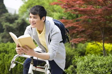 Male college student reading a book