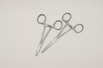 Two clamping scissors lying on white background