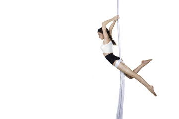 Athletic woman doing some tricks on silks