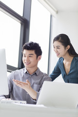 Young business person talking in office