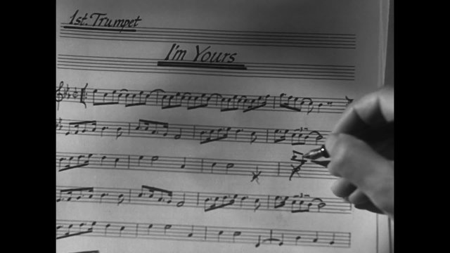Close-up of hand with pen correcting music sheet