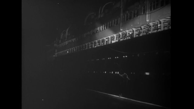 Passenger ship leaving  port at night, 1940s