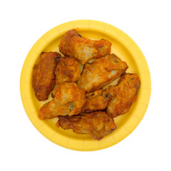 Serving of chicken wings on a yellow paper plate