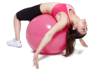 Fototapeta premium Young woman stretching on a fitness ball