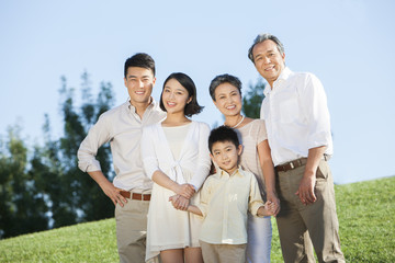 Portrait of big family smiling in a park
