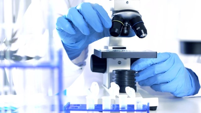 Researcher Working in Lab With Microscope.researcher in biochemical lab