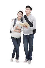 Fototapeta premium Cheerful college couple looking at view