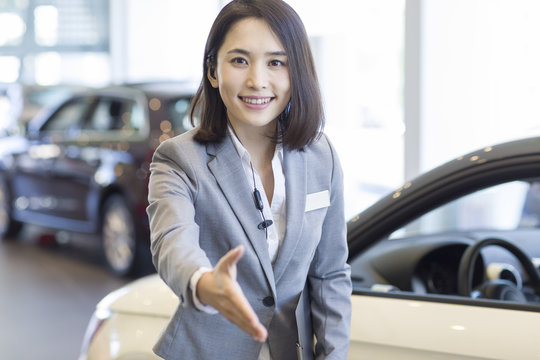 Car saleswoman greeting
