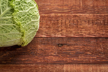 Fototapeta premium savoy cabbage on rustic wood