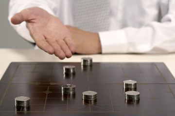 Office worker playing Chinese chess with investment capital