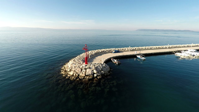 Aerial view of port entrance with red beacon