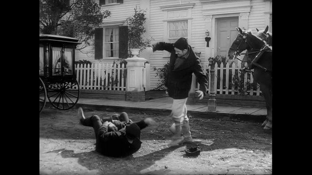 Two men beating up another man in small town