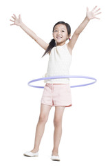 Happy girl spinning plastic hoop