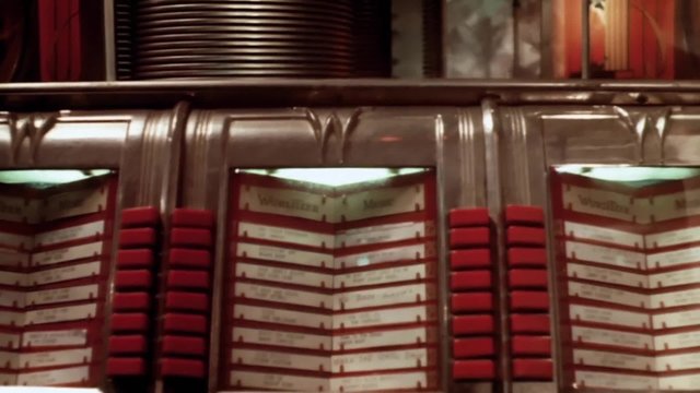 Close-up of person pressing button on jukebox