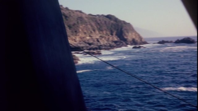 Water wheel rotating  by the ocean, 1960s