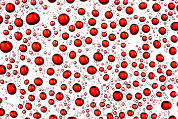 Red water drops on glass surface texture.