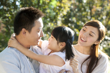 Fototapeta premium Young Chinese family in a park