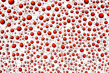 Red water drops on glass surface texture.