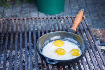 Fried eggs fried in a pan on the grill
