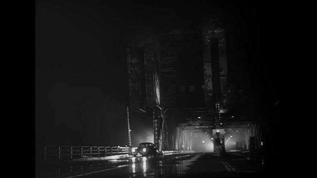 Car stopping on bridge at night, Los Angeles, California, 1940s