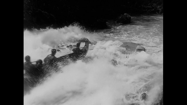 People rafting down mountain river, 1940s
