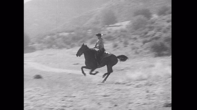 Wide shot of  cowboy horseback riding across the plains, 1930s