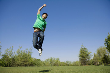 Young man jumping in air at park