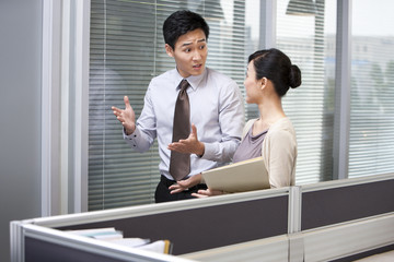 Young Businessman Talking to Young Businesswoman