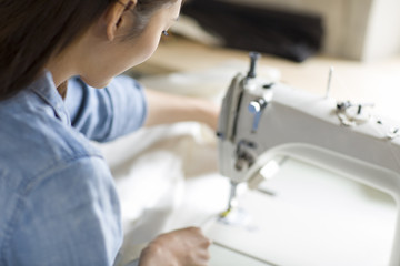 Fashion designer using sewing machine