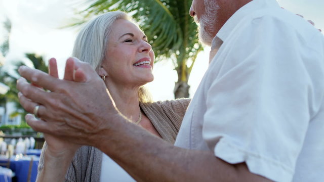 Retired Caucasian couple evening dancing together at a vacation hotel