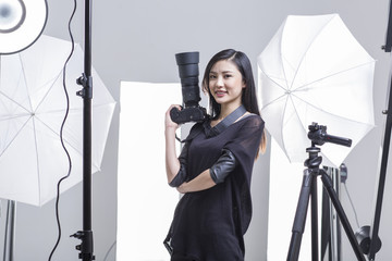 Photographer standing in studio with camera