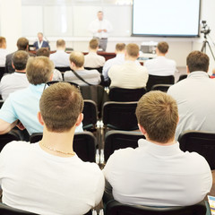 The audience listens to the acting in a conference hall