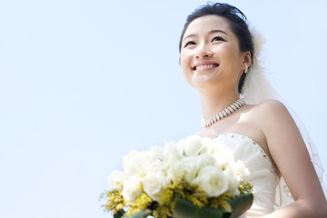 Happy bride holding bouquet