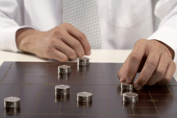 Office worker playing Chinese chess with investment capital