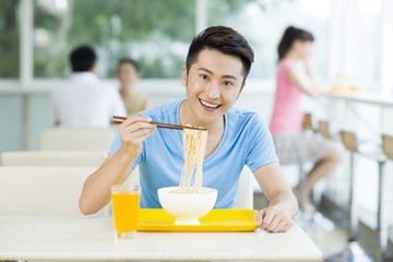 Young man having a meal in restaurant