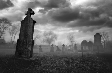 Fototapeta Old creepy graveyard on stormy winter day in black and white obraz