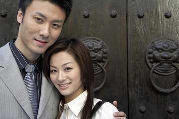 Businesspeople Standing With Arms Around Each Other