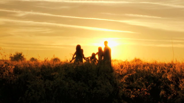 Carefree Caucasian Family Enjoying Vacation Together Outdoors Sunrise Silhouette