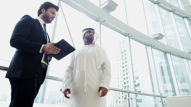 Western Caucasian Arabic male business banking finance technology tablet 