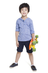 Little boy holding a skateboard