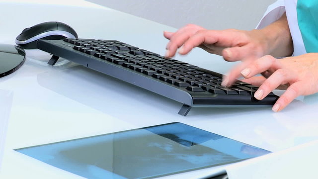 hands Caucasian Western female doctor consultant medical keyboard x-ray 