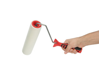 Naklejka premium Paint roller in man's hand