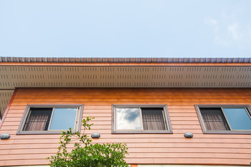 roof on a wood house with blue sky