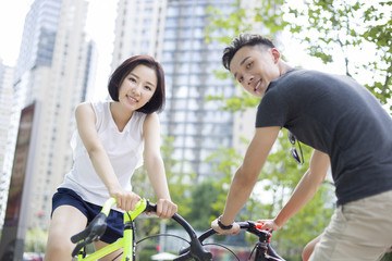 Happy young couple riding bicycles