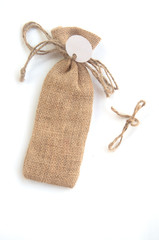 burlap sack with tag on white,souvenir in wedding