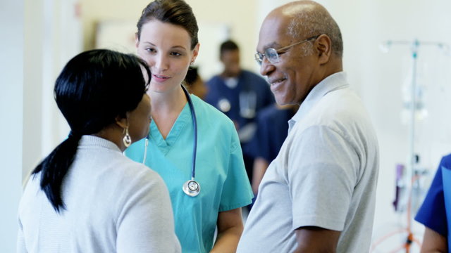 Caucasian female nurse consult with African American couple patient in hospital