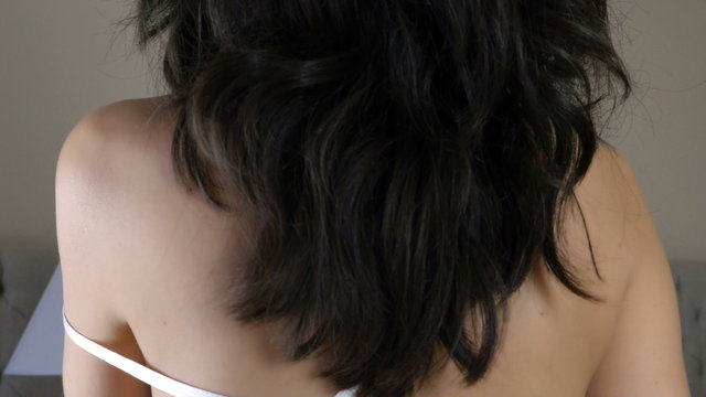 woman taking off her nightdress in a bedroom