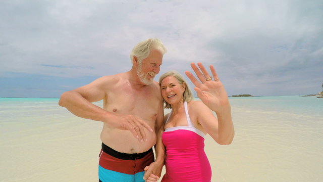 Loving Caucasian senior couple in swimwear on tropical vacation beach