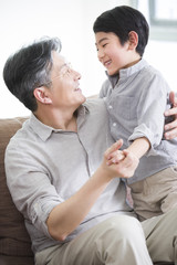Obraz premium Happy grandfather and grandson dancing
