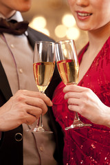 Young couple having champagne in a luxurious room